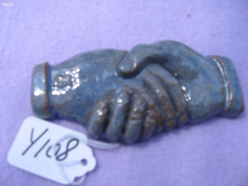 Shaking Hands. Clay with Blue and Brown Glaze on