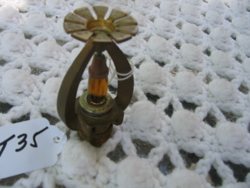 Sprinkler Head. Amber Liquid still in middle. Ma