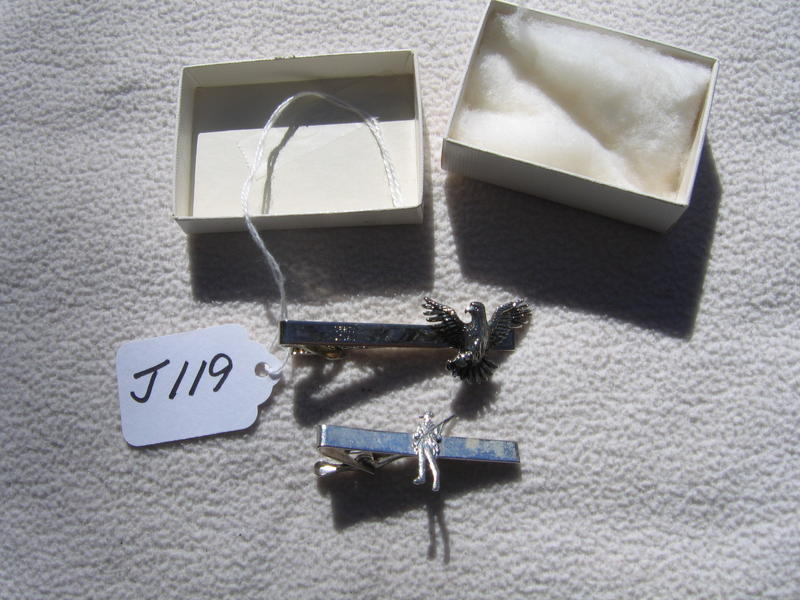 Two Different Tie Tacks. One is for Liberty Mutua