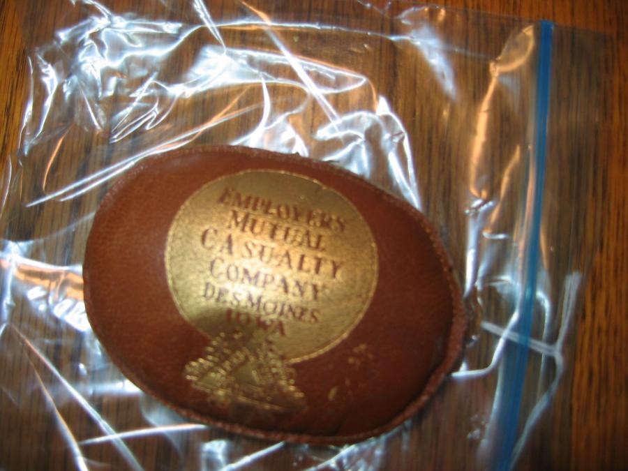 #136 Employers Mutual Casualty. Des Moines, Iowa. Leather Beanbag Advertising Piece. 4 by 2 ¾ inches.