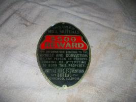 Oval aluminum sign offering a $500.00 reward for i