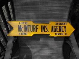 Unusual Insurance Agency Sign in shape of an arrow
