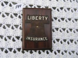 Liberty Insurance Auto Tag/Badge. Mounted on Wood