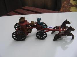 #024 Heavy Metal Fireman toy with two horses pulling a steam fire engine.